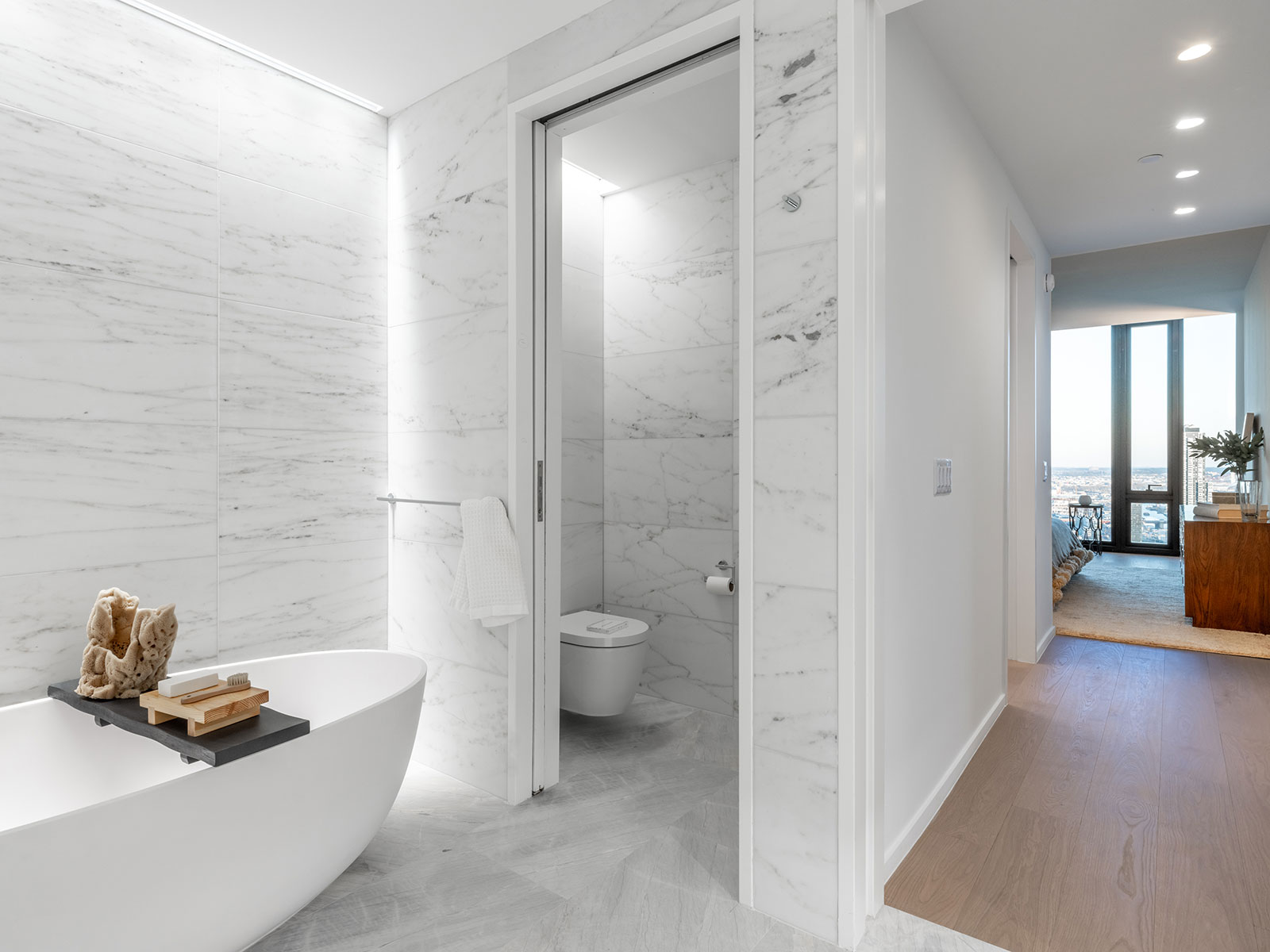 Beautiful marble bathroom with modern design and a standalone bathtub at 685 First Avenue, apartments for rent in Murray Hill