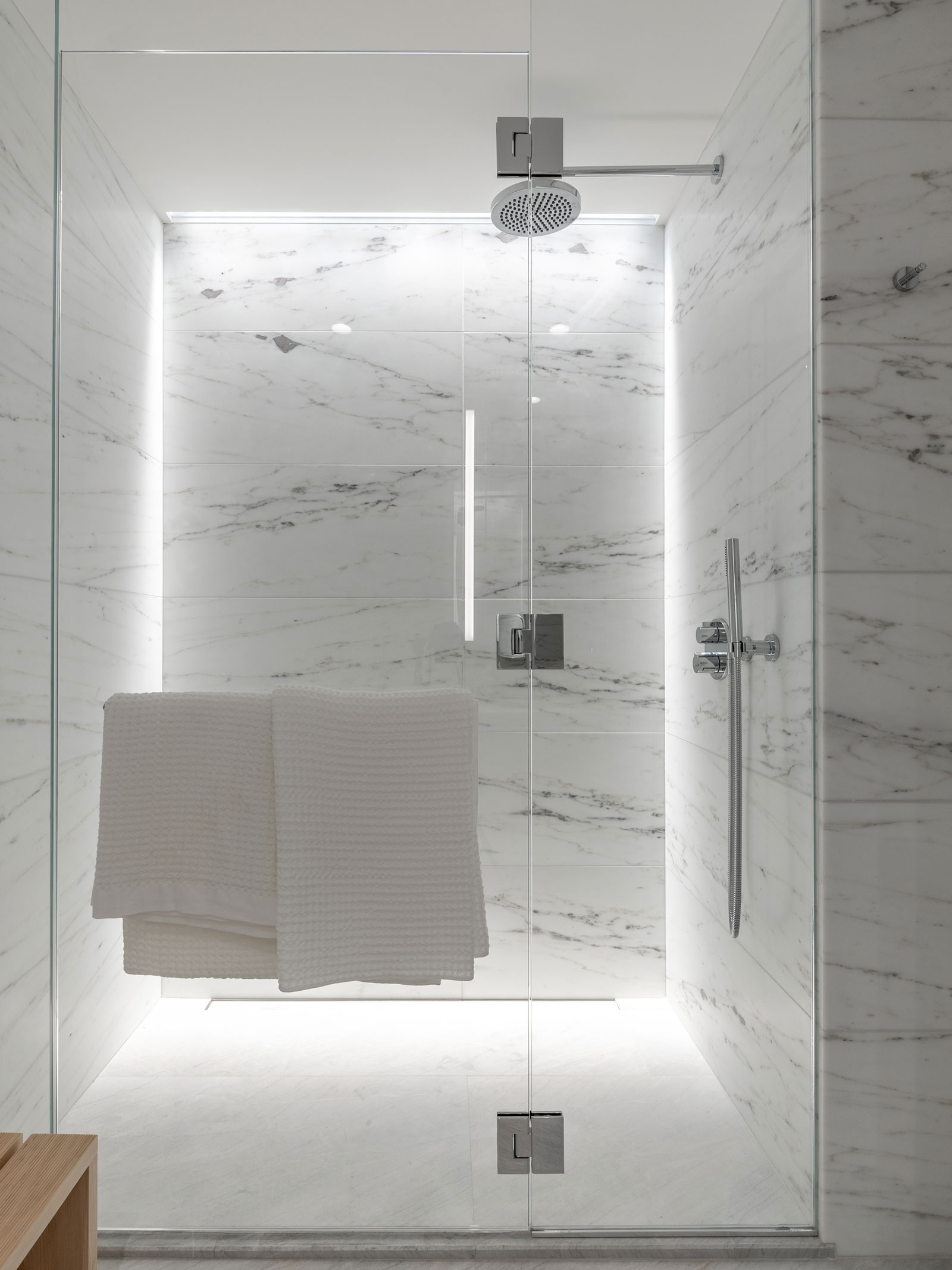 Modern bathroom with high ceilings, white marble finishes, and rain shower at 1st Avenue, Murray Hill rentals